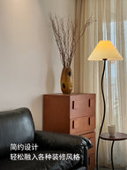 Vintage-style floor lamp ambiance, living room sofa, several high-end bedroom storage racks, standing desk lamp with artistic touch